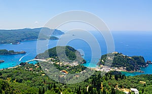 Paleokastritsa beach and village on Corfu island, Greece. Picturesque seashore with turquoise crystal water, pebble beach,mountain