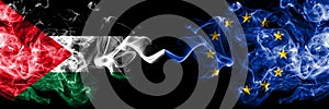 Palestine vs European Union, EU smoky mystic flags placed side by side. Thick colored silky smokes flag of Palestinians and