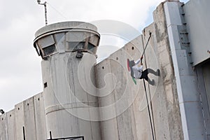 Palestinian climbs Israeli separation wall