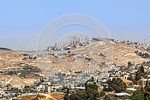 Palestinian village and town separated by wall.