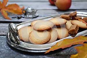 Palets bretons, french cookies. Salted caramel Shortbread Breton cookies and autumn leaves photo