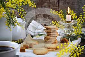 Palets bretons, french cookies. Salted caramel Shortbread Breton cookies and bouquet of mimosa