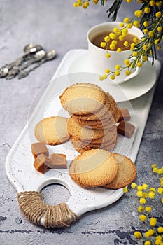 Palets bretons, french cookies. Salted caramel Shortbread Breton cookies, cup of coffee and mimosa photo