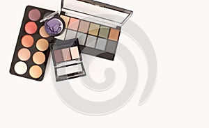 Palette box pearl pink and beige, bronze circle eyeshadows, powder. Cosmetics on light copy space background. Flat lay, top view