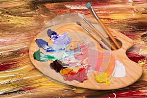 Palette with brushes on desk