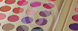 Palette of dry pressed eyeshadows in neutral tones, banner. Round refills of purple, pink, crimson shades. Beauty concept,
