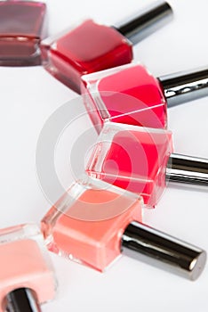 A palette of nail polish bottles on a white background