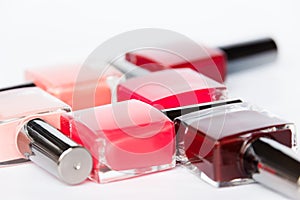 A palette of nail polish bottles on a white background