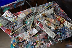 Palette with paint tubes and brusher