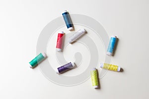 Palette of spool of threads on yellow paper background