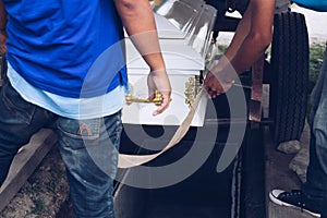 Pallbearers carefully oversee the process of lowering the casket to the ground for the deceased to its final place of rest