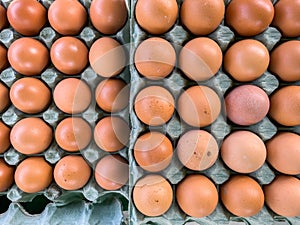 Pallet with brown eggs. Close-up fresh eggs for sale at a market.