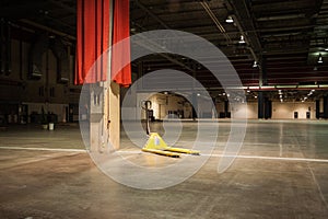 Pallet jack sits in empty convention hall photo