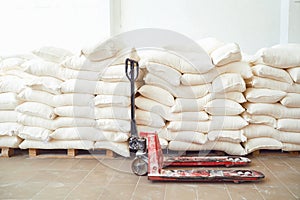 Pallet trask in stock with bags of flour in storage