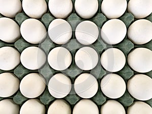 Pallet with white eggs. Close-up fresh eggs for sale at a market.