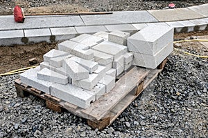 Pallet of white paving stones at a construction site