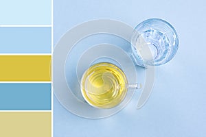 Pallete of colors Glass of water, cup of green tea on blue table Top view Flat lay Style life Beverages, drink and lose weight