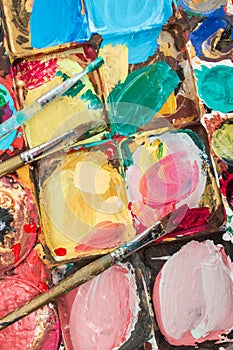 A pallete with three brushes