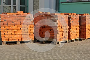 Pallets with red bricks