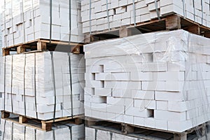 Pallets with white bricks. Building materials wholesale