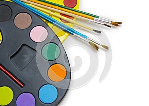 Pallette with brushes on a white background
