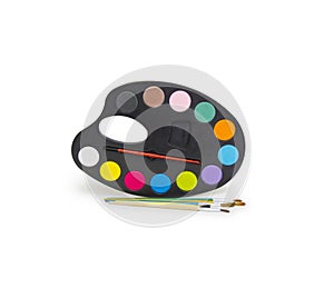 Pallette with brushes on a white background