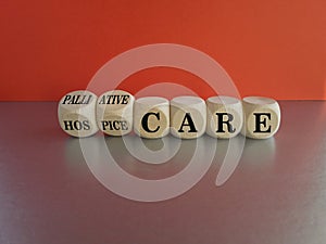 Palliative or hospice care symbol. Concept word Palliative care Hospice care on wooden cubes. Beautiful grey table red background