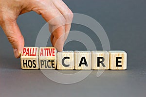 Palliative or hospice care symbol. Concept word Palliative care Hospice care on wooden cubes. Doctor hand. Beautiful grey table