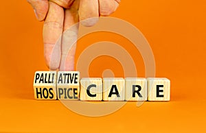 Palliative or hospice care symbol. Concept word Palliative care Hospice care on wooden cubes. Doctor hand. Beautiful orange