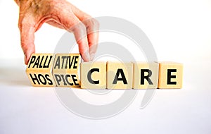 Palliative or hospice care symbol. Concept word Palliative care Hospice care on wooden cubes. Doctor hand. Beautiful white table