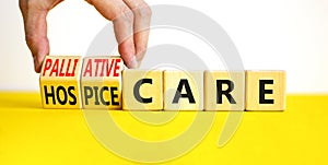 Palliative or hospice care symbol. Concept word Palliative care Hospice care on wooden cubes. Doctor hand. Beautiful yellow table