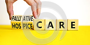 Palliative or hospice care symbol. Concept word Palliative care Hospice care on wooden cubes. Doctor hand. Beautiful yellow table