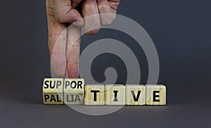 Palliative or supportive therapy symbol. Doctor turns cubes, changes words palliative to supportive. Beautiful grey background,