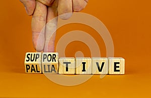 Palliative or supportive therapy symbol. Doctor turns cubes, changes words palliative to supportive. Beautiful orange background,