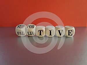 Palliative or supportive therapy symbol. Turned cubes, changes words palliative to supportive. Beautiful red background, copy