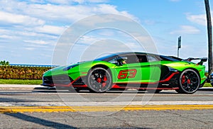 Palm Beach, Florida USA - March 21, 2021: green Lamborghini Aventador car on road in palm beach