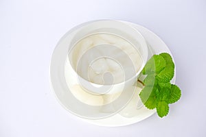 Palm fruit with syrup or fruto de palmeira in a separate bowl on white background. photo