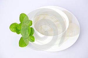 Palm fruit with syrup or fruto de palmeira in a separate bowl on white background. photo