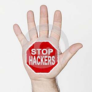 On the palm of the hand there is a stop sign with the inscription - STOP HACKERS