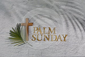 Palm sunday background. Cross and palm on grey background.