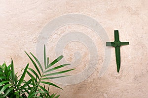 Palm Sunday concept. Cross made of palm and tropical leaves. Christian moveable feast to celebrate Jesus' triumphal photo