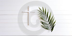 Palm Sunday. Cross and palm leaf on white wooden background with copy space. Christian concept