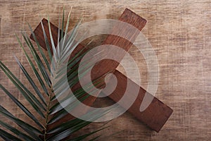 Palm Sunday. Palm brunch on wooden background with cross. Easter