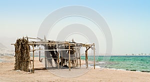 Palm tree hut with garbage on the shores of the Red Sea in Egypt Dahab