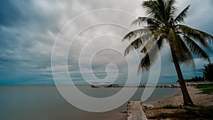 Palm tree and  walkeway in front of Dilapidated old fishing dock collapsing into the sea in Pak Nam Pran Thailand photo