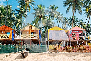 Palm trees and bungalow in Palolem beach, Goa, India