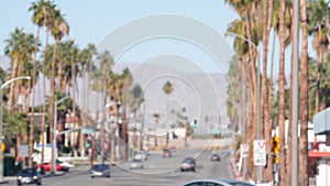 Palm trees, Palm Springs city street, road traffic, California USA. Cars driving