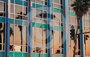 Palm trees reflection at sunset on windows glass building in Tel Aviv - ISRAEL