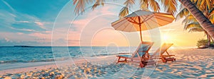 Palm trees sway in the wind as chairs and umbrellas dot the beach at sunset