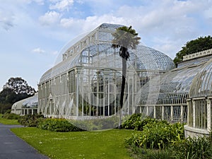 Palmiarnia building in the Park Wilsona, Poznan. Beautiful glass house in the city. Greenhouse with plants inside